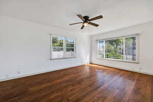 Spare room featuring dark hardwood / wood-style floors and ceiling fan