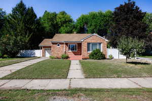 View of front of house featuring a garage and a front lawn