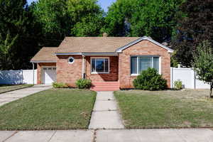 View of front of home with a garage and a front yard