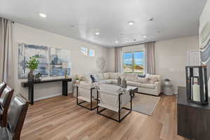 Living room with a textured ceiling and light wood-type flooring