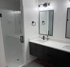 Bathroom featuring vanity and a shower with shower door