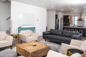 Living room with light wood-type flooring and sink