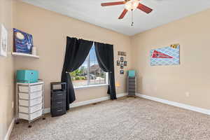 Unfurnished office featuring ceiling fan and light colored carpet