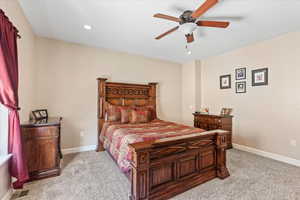 Bedroom featuring ceiling fan and light carpet