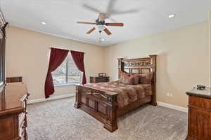 Carpeted bedroom featuring ceiling fan