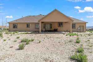 Rear view of house featuring a patio