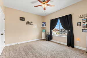 Unfurnished room with ceiling fan and carpet floors