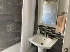 Bathroom featuring plus walk in shower and sink