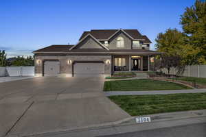 View of front of home featuring a yard and covered porch