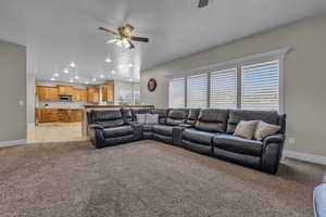 Living room featuring ceiling fan and light carpet