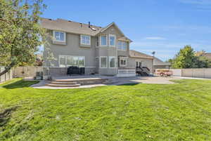 Rear view of house with a lawn and a patio area