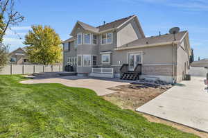 Back of property featuring a patio, a yard, and french doors