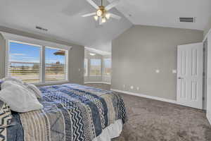 Carpeted bedroom featuring lofted ceiling and ceiling fan