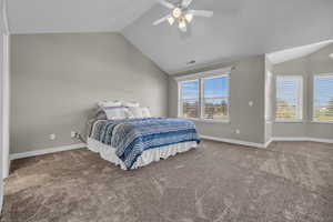 Upstairs master Carpeted bedroom featuring ceiling fan, lofted ceiling, and multiple windows