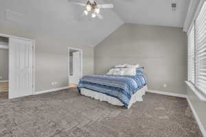 Upstairs master Bedroom with ceiling fan, carpet floors, and vaulted ceiling