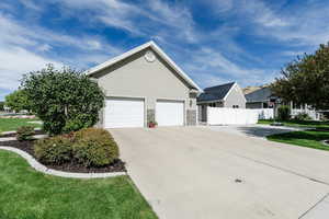 View of front of house featuring a garage and a front lawn