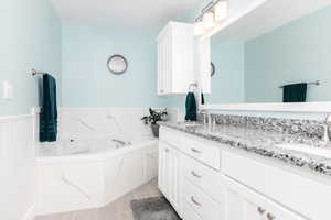 Bathroom featuring a bath and vanity