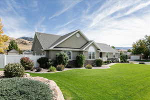 Single story home with a front yard and a mountain view