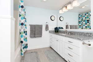 Bathroom with hardwood / wood-style floors and vanity