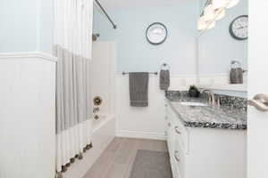 Bathroom with vanity and shower / bathtub combination with curtain