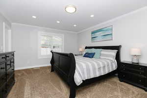 Bedroom featuring carpet and ornamental molding