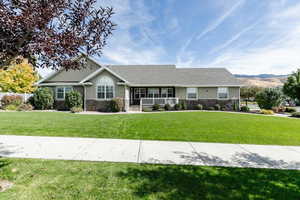 Ranch-style home with a front lawn and covered porch