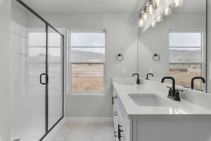 Bathroom with vanity and a shower with shower door