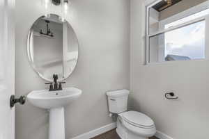 Bathroom featuring wood-type flooring and toilet