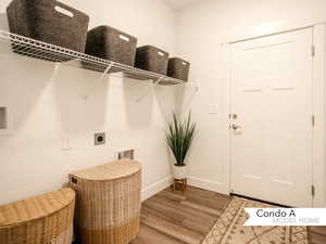 Clothes washing area with hookup for an electric dryer, light hardwood / wood-style floors, and hookup for a washing machine