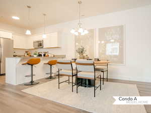 Dining area featuring light hardwood / wood-style floors and a chandelier