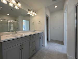 Bathroom featuring vanity and an enclosed shower