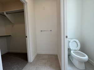 Bathroom with tile patterned floors and toilet