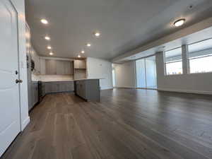 Kitchen featuring gray cabinets, dark hardwood / wood-style floors, range, and a kitchen island