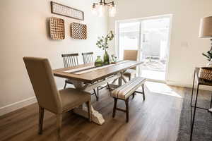 Dining room featuring dark hardwood / wood-style flooring and a chandelier