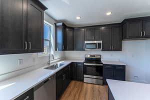 Kitchen featuring light hardwood / wood-style flooring, appliances with stainless steel finishes, and sink