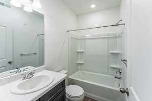 Full bathroom with shower / bathtub combination, vanity, and toilet