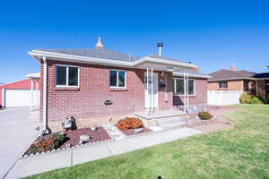 Ranch-style house with a front yard and a garage