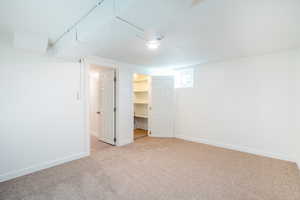 Unfurnished bedroom with a spacious closet, light carpet, and a closet