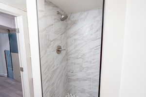 Bathroom featuring a tile shower