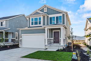 Craftsman inspired home featuring a front yard, cooling unit, a garage, and a mountain view