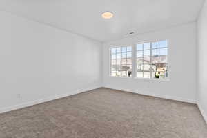 Unfurnished room featuring carpet