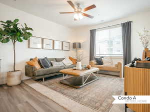 Living room with hardwood / wood-style floors and ceiling fan