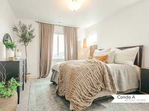 Bedroom featuring light colored carpet