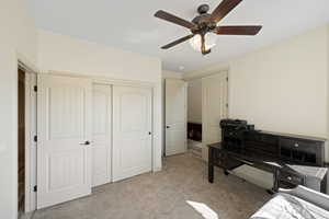 Carpeted bedroom with ceiling fan