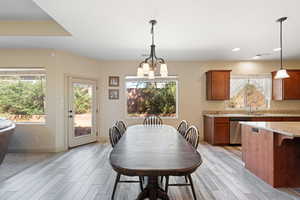 Dining area featuring light hardwood / wood-style floors, sink, and a chandelier