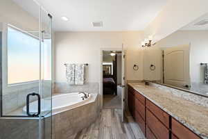 Bathroom with independent shower and bath, vanity, wood-type flooring, and ceiling fan