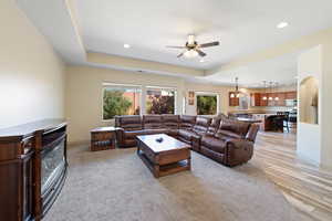 Living room featuring ceiling fan and light hardwood / wood-style flooring