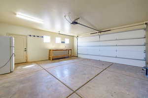 Garage featuring white fridge