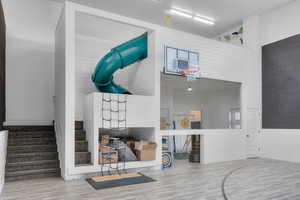 Living room with wood-type flooring and a high ceiling