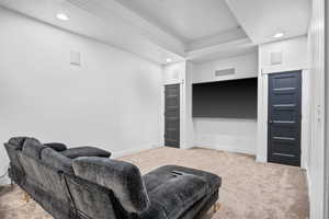 Living room featuring carpet and a textured ceiling